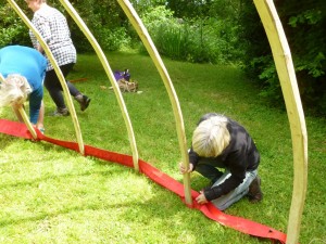 Fitting the poles into the new loops in the tension band